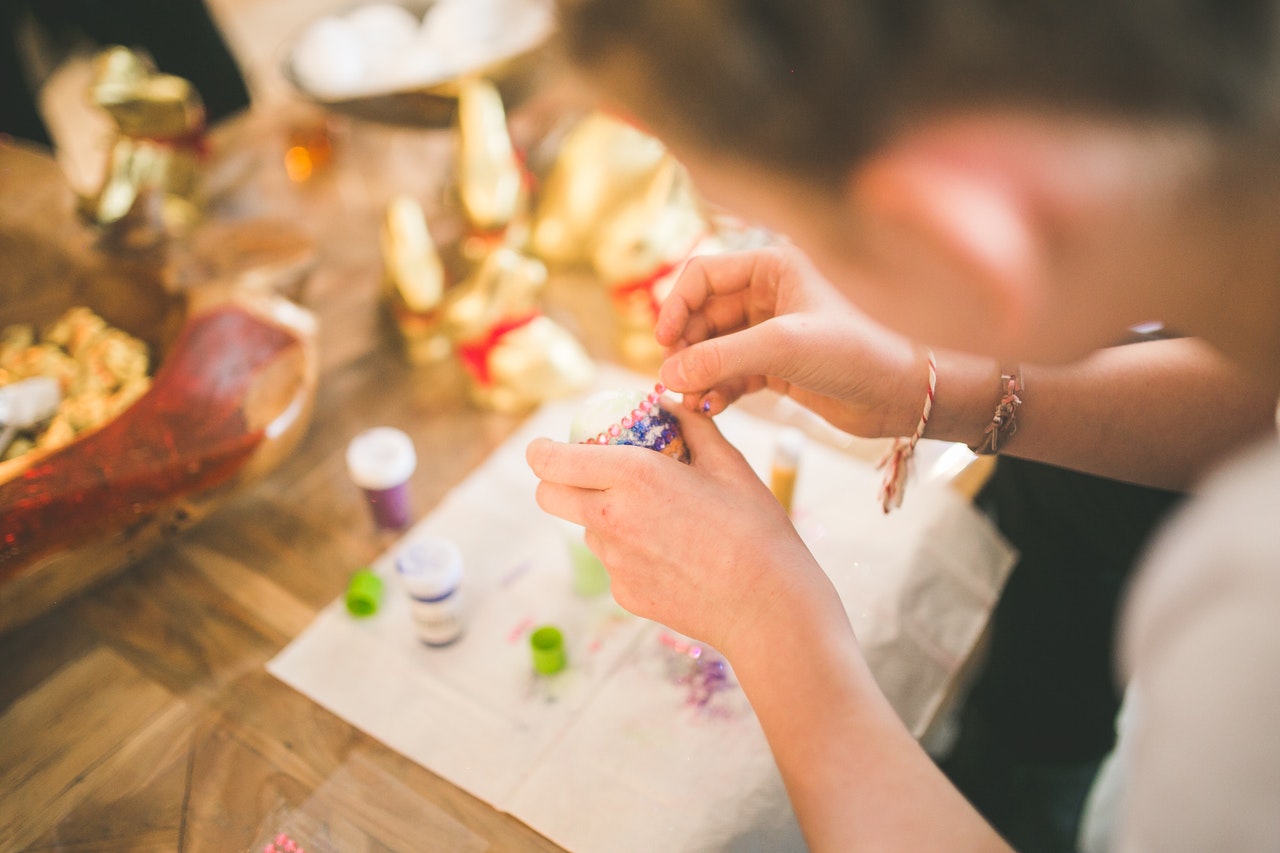image of a person's hands making something with craft materials
