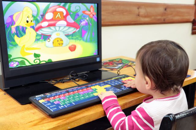 toddler uses awe station. screen shoes a yellow duck and mushroom