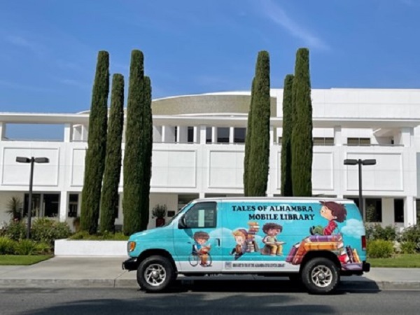 image of library mobile van parked in front of library building