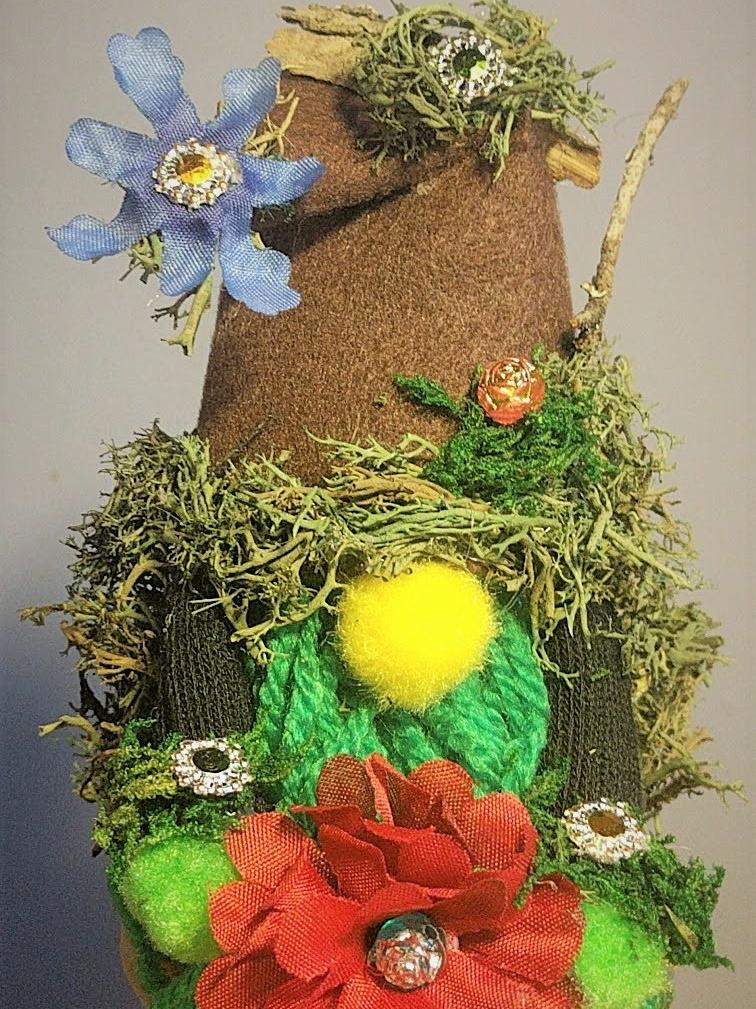 image of a garden gnome with moss and flowers