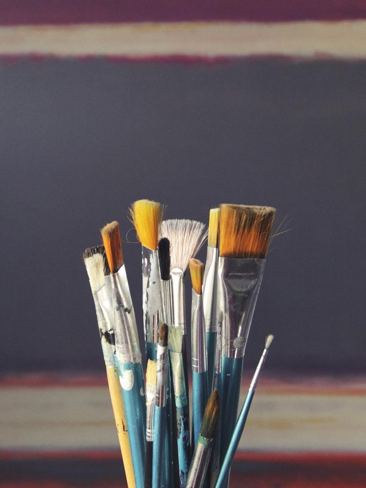 image of a set of brushes in front of a wall