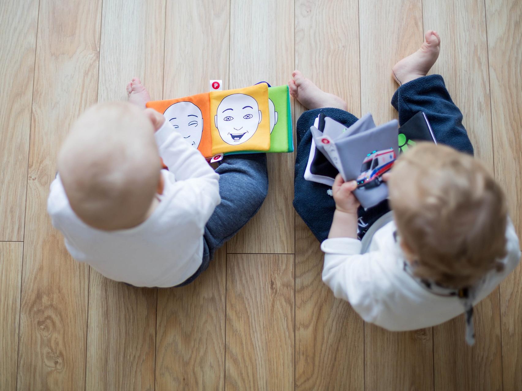 two babies reading books